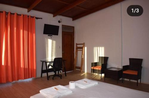a room with a bed and a table and chairs at Mangata in Lobitos