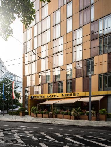 a building with a sign for a hotel at AMERON Köln Hotel Regent in Cologne