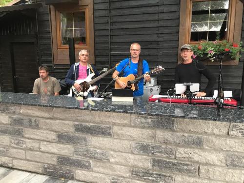 a group of men standing around a counter playing music at Waldrestaurant VIDA in Kapfenberg