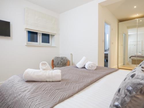 a bedroom with a large bed with towels on it at Seaview in Dartmouth