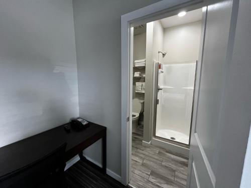 a bathroom with a glass door leading to a toilet at Longhorn Flats in Loving