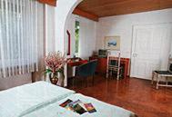 a bedroom with a bed and a living room at Hotel Starkenburger Hof in Heppenheim an der Bergstrasse