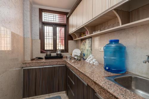 a kitchen with a large blue jug on the counter at (TF) Entire Indpndnt Private 2 BHK Flat,Nr Airport in New Delhi