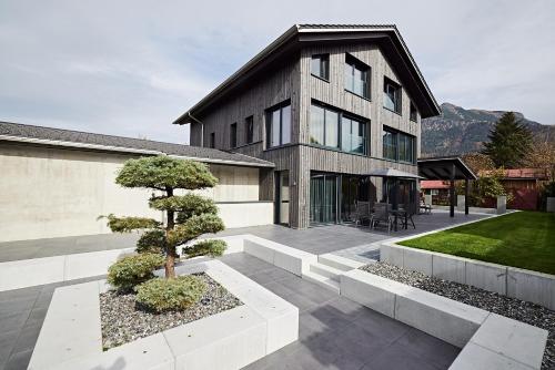 a house with a tree in front of it at dasVolks in Oberstdorf