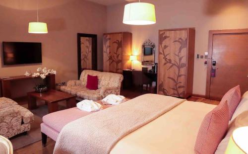 a hotel room with a bed and a chair at Tigerlily in Edinburgh