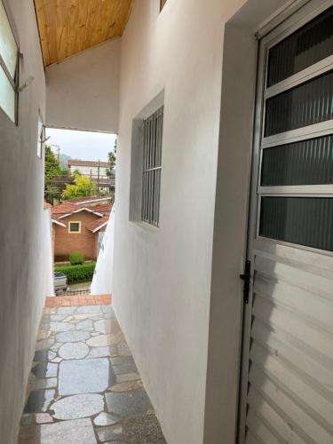 a walkway leading to a door in a house at Apartamentos Dumont in Monte Verde