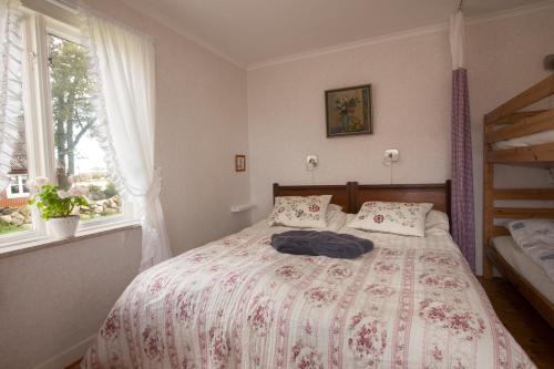 een slaapkamer met een bed en 2 ramen bij Hermanslycke Bed & Breakfast in Tvååker
