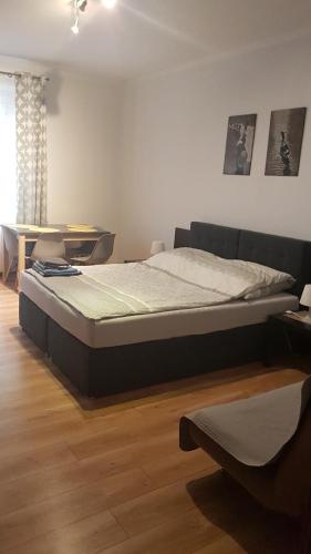 a bedroom with a bed and a table and a window at Apartament Skwer Kosciuszki Morze in Gdynia