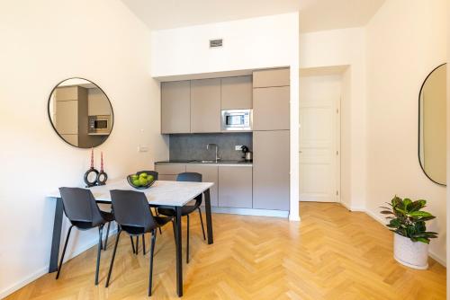 a kitchen and dining room with a table and chairs at Petrin Tower Residence in Prague