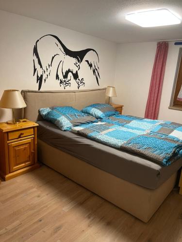 a bedroom with a bed with a wolf sticker on the wall at Appartementhaus Silke in Bad Füssing