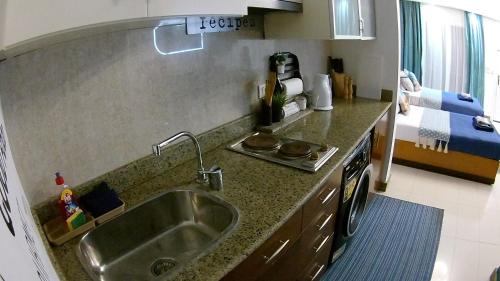 a kitchen with a sink and a counter top at Deluxe Apartment Delta Sharm in Sharm El Sheikh