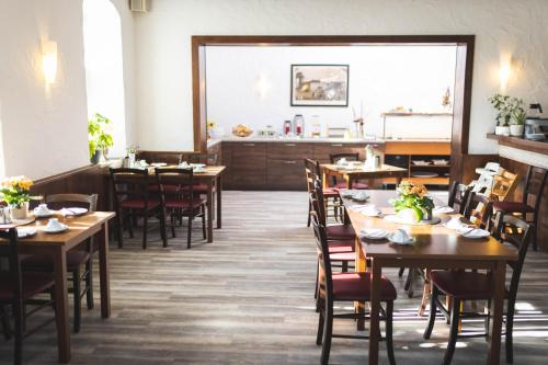 a dining room with wooden tables and chairs at Pension Friedrichshof in Bad Klosterlausnitz
