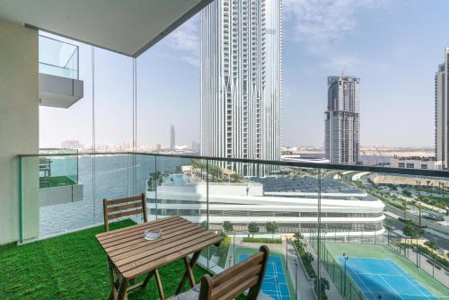 a balcony with a table and a view of a city at Lux BnB The Grand Creek Harbor Views in Dubai