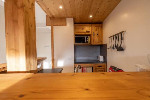 une cuisine avec des armoires en bois et une table en bois dans l'établissement Amanuq lovely apartment, à Chamonix-Mont-Blanc