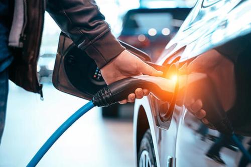 a person charging a car with a charger at Staybridge Suites Ann Arbor - Research Parkway by IHG in Ann Arbor