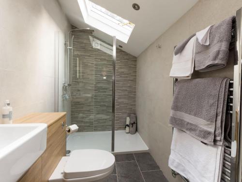a bathroom with a shower and a toilet and a sink at Beverley Minster House in Beverley