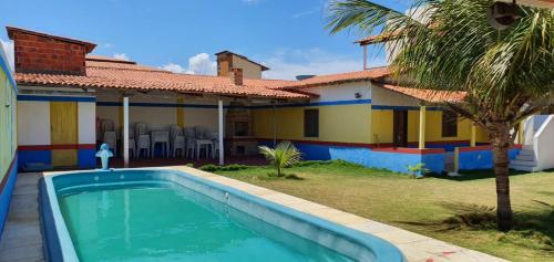 a swimming pool in front of a house at Dunas Bar&Hotel in Canoa Quebrada
