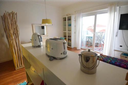 a kitchen counter with two toasters on top of it at Yellow Submarine on the seafront in Silveira
