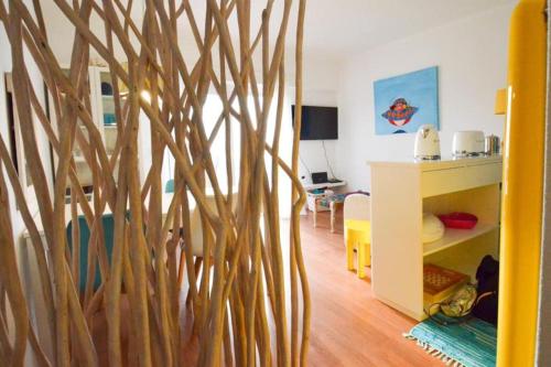 a living room with a wooden tree wall at Yellow Submarine on the seafront in Silveira