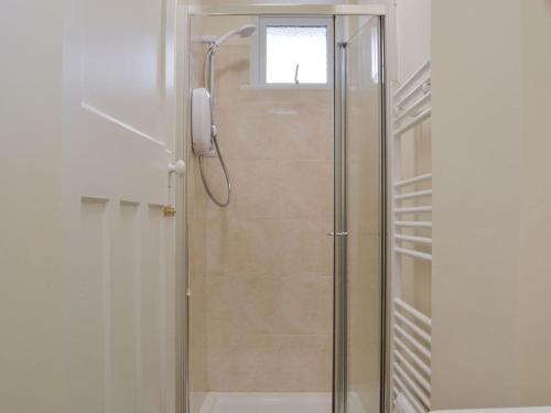 a shower with a glass door in a bathroom at Ashlea in Teversal