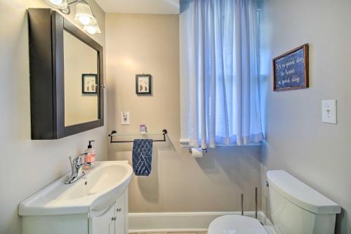 a bathroom with a sink and a toilet and a mirror at North Beach Cottage - Walk to Chesapeake Bay in North Beach