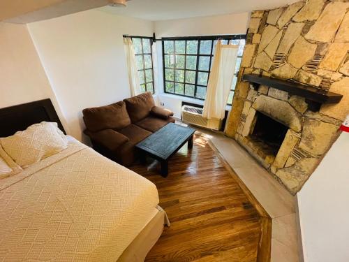 a bedroom with a bed and a fireplace at Hotel Chipinque in Monterrey