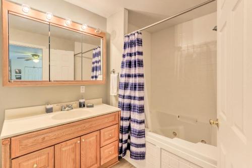 a bathroom with a sink and a shower and a tub at Harpers Ferry Cabin - Walk to Private Lake! in Harpers Ferry