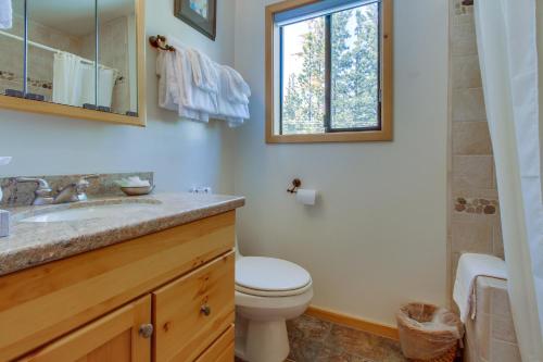a bathroom with a toilet and a sink and a window at Val D'Isere 45 in Mammoth Lakes