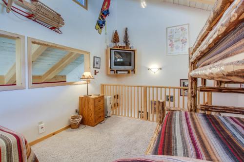 a bedroom with a bunk bed and a tv at Val D'Isere 45 in Mammoth Lakes