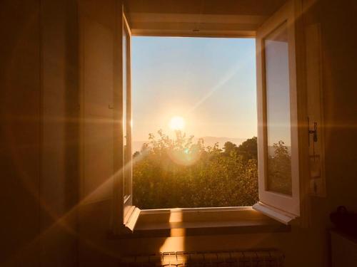 an open window with a view of the sunset at AGRI ART in San Benedetto Ullano