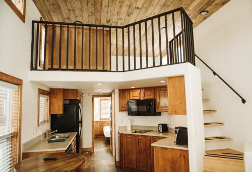 a kitchen with a spiral staircase in a house at Teton Valley Resort in Victor