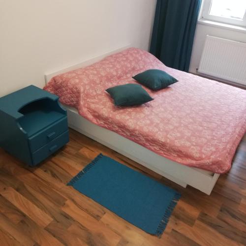 a small bed with two pillows and a blue box at Ruud Mall in Timişoara