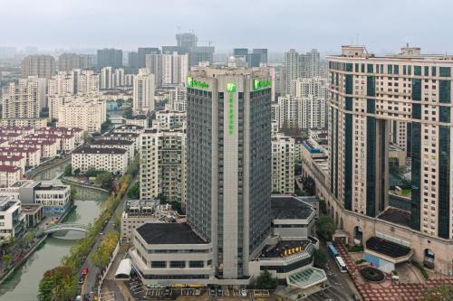 an aerial view of a city with tall buildings at Holiday Inn Shanghai Huaxia by IHG - overlooking city scenery at Sky View Restaurant in Shanghai