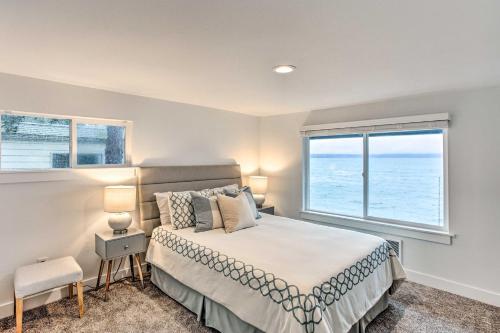 a bedroom with a bed and a large window at Tacoma Dash Point Beach Cabin with Balcony! in Tacoma