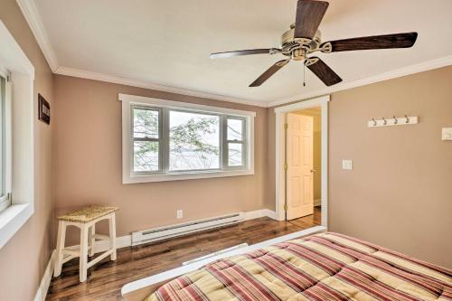 a bedroom with a ceiling fan and a bed at Waterfront Cottage on Sawmill Bay with Deck! in Clayton