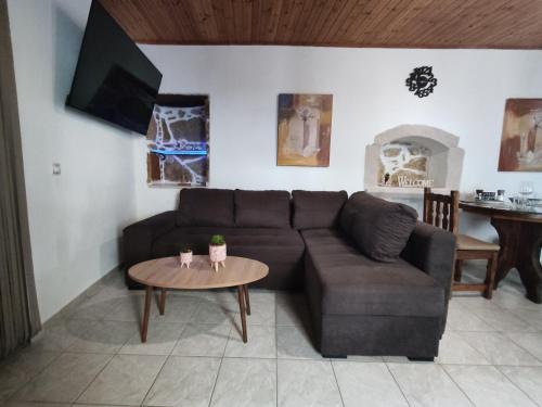 a living room with a couch and a table at Irini's Home - Pitsidia in Pitsidia