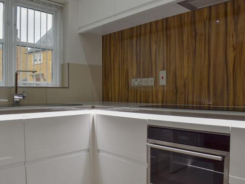 a kitchen with white cabinets and a sink at Hollies Cottage 7 - Ukc4523 in Martock