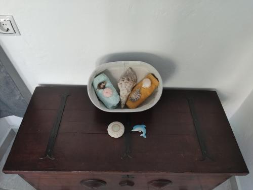 a wooden table with a container of soap on it at Irini's Home - Pitsidia in Pitsidia