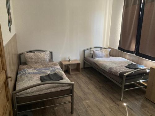 a bedroom with two beds and a night stand at Ferienwohnung Funke F3 für Monteure in Apolda