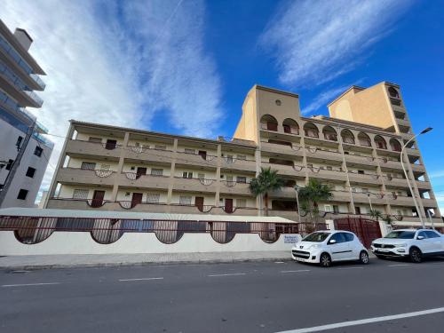 a large building with two cars parked in front of it at Alpen1 La Volta in Peniscola