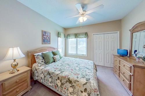 a bedroom with a bed and a ceiling fan at Tidewater Retreat in North Myrtle Beach