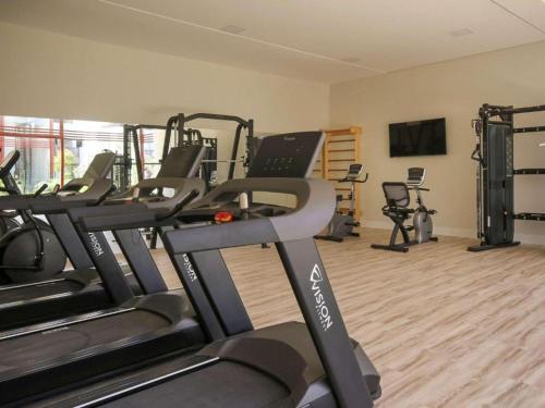 a gym with treadmills and machines in a room at Île de Pipa com Hidromassagem in Pipa