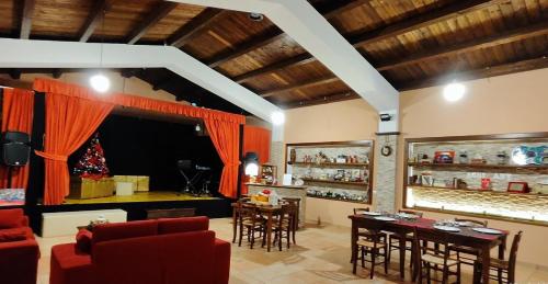 a living room with red furniture and a bar at AGRI ART in San Benedetto Ullano