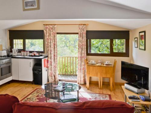 a living room with a table and a kitchen at Bannsvale Summer House - W43195 in St. Agnes