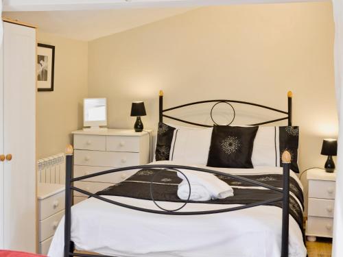 a bedroom with a black and white bed at Bannsvale Summer House - W43195 in St. Agnes