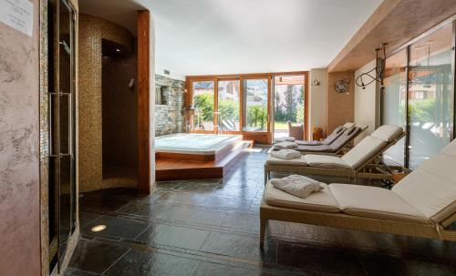 a living room with three couches and a shower at Sottovento Luxury Hospitality in Bormio