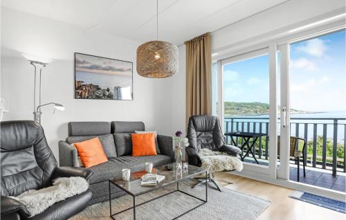 a living room with a couch and chairs and a balcony at Nice Apartment In Allinge With Wifi in Allinge