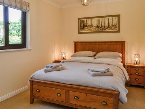 a bedroom with a bed with two towels on it at Park Lane in Auldgirth