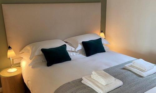 a bedroom with a white bed with two pillows at Yorkshire Dales Lodge 3 Family 3 Bed in Richmond