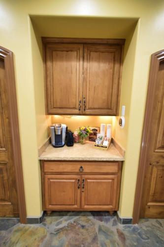 a kitchen with wooden cabinets and a counter top at Peppertree Lane Ranch -- Seven-Acre Ranch in the Heart of Wine Country in Temecula